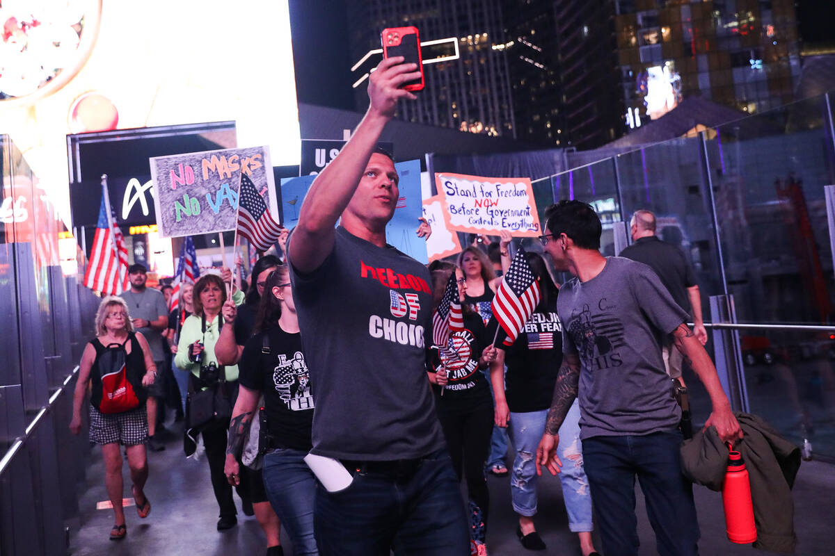 Brandon Burns, founder of the non-profit Freedom of Choice, leads protesters on the Strip to pr ...