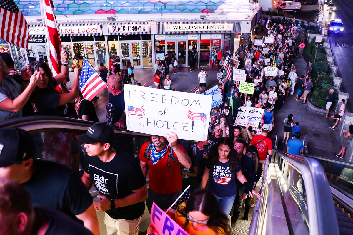Protesters walk the Strip to protest COVID-19 government mandates, hosted by the non-profit Fre ...