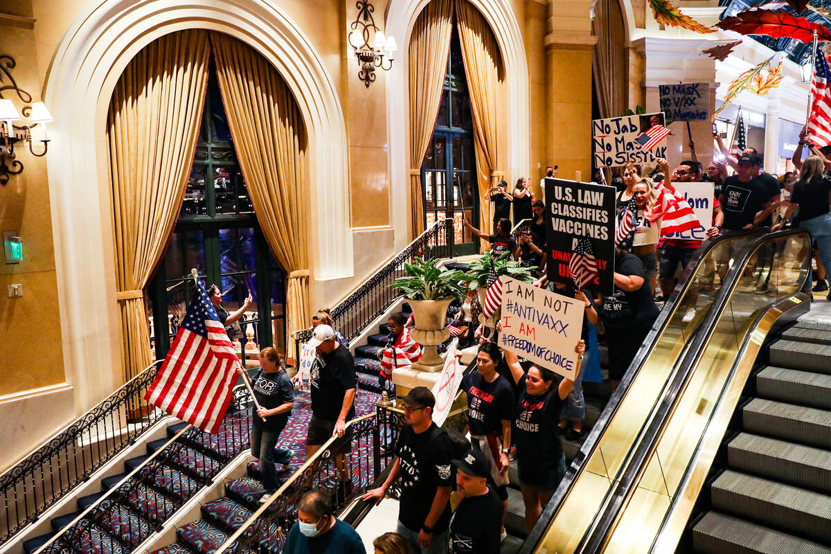 Protestors walk through the Bellagio to protest COVID-19 government mandates, hosted by the non ...
