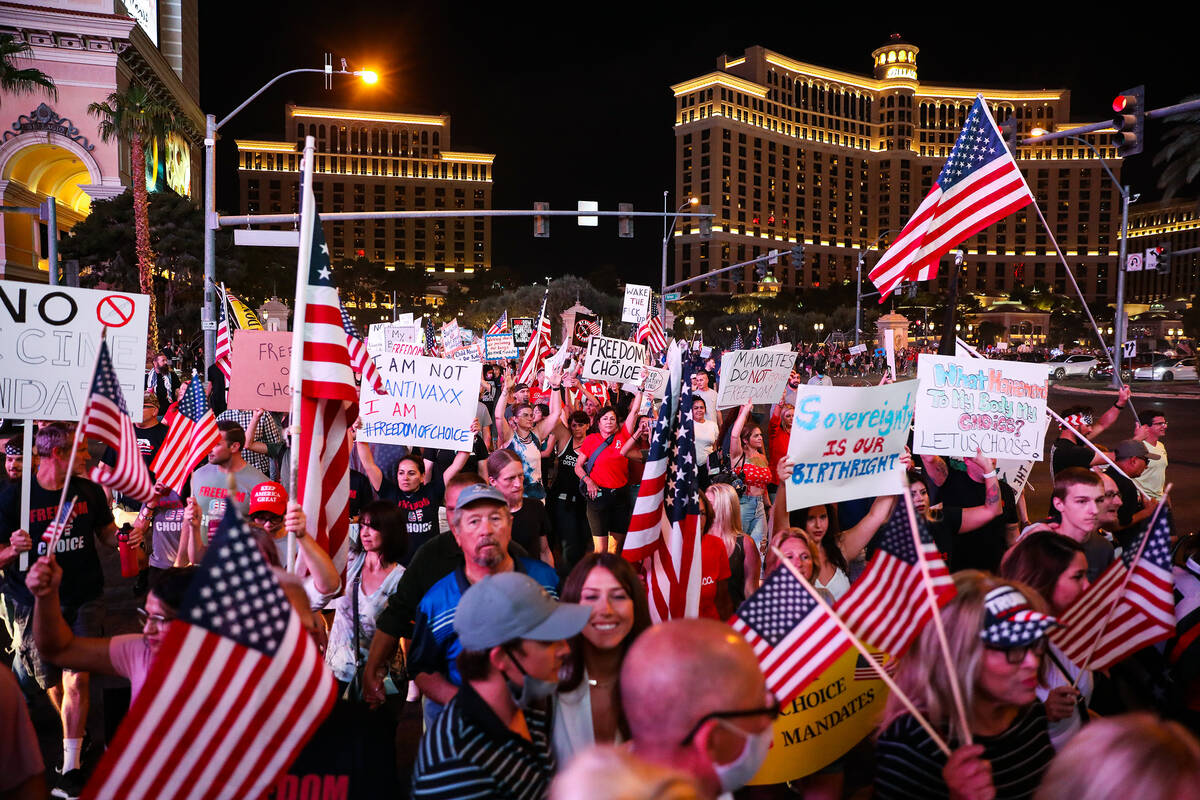 Protesters walk the Strip to protest COVID-19 government mandates, hosted by the non-profit Fre ...