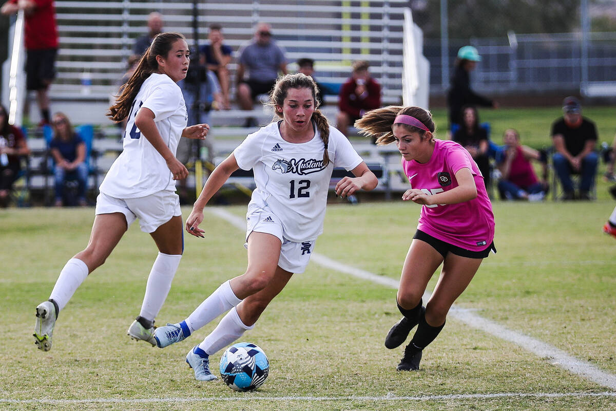 Shadow Ridgeճ Loegan Alia (12) attempts to pass Desert OasisՠMia Brown (25) during ...