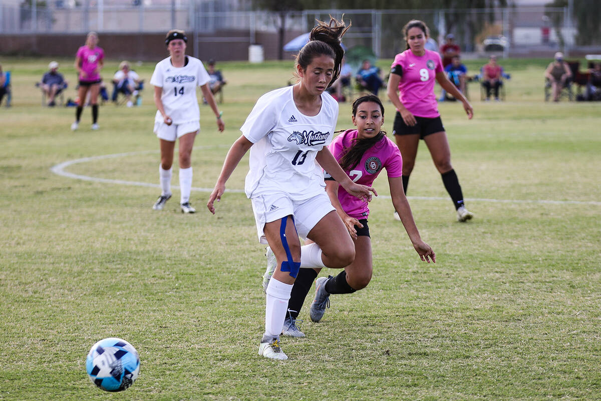 Shadow Ridgeճ Leighanne Kim (18) blocks Desert OasisՠJessica Leon (7) from getting ...