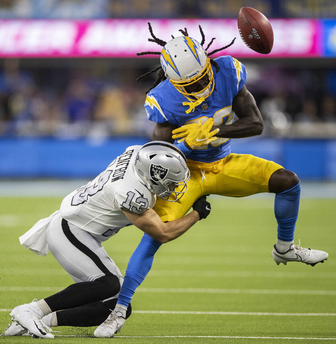 Raiders wide receiver Hunter Renfrow (13) breaks up a pass attempt to Los Angeles Chargers defe ...