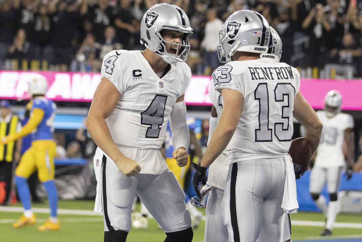 Raiders quarterback Derek Carr (4) celebrates a touchdown with Raiders wide receiver Hunter Ren ...