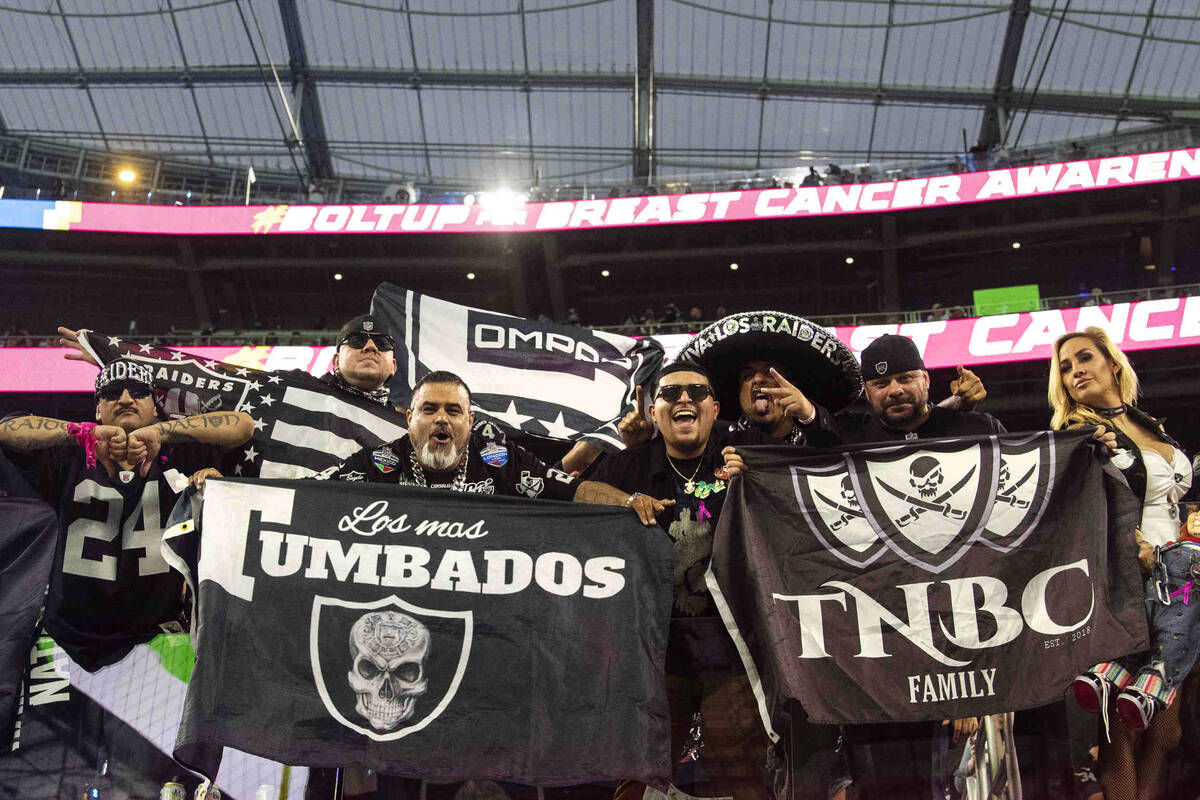 Raiders fans pose for a photo before an NFL football game between the Raiders and the Los Angel ...