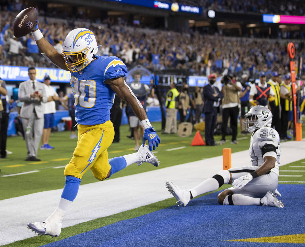 Los Angeles Chargers running back Austin Ekeler (30) scores a touchdown past Raiders outside li ...