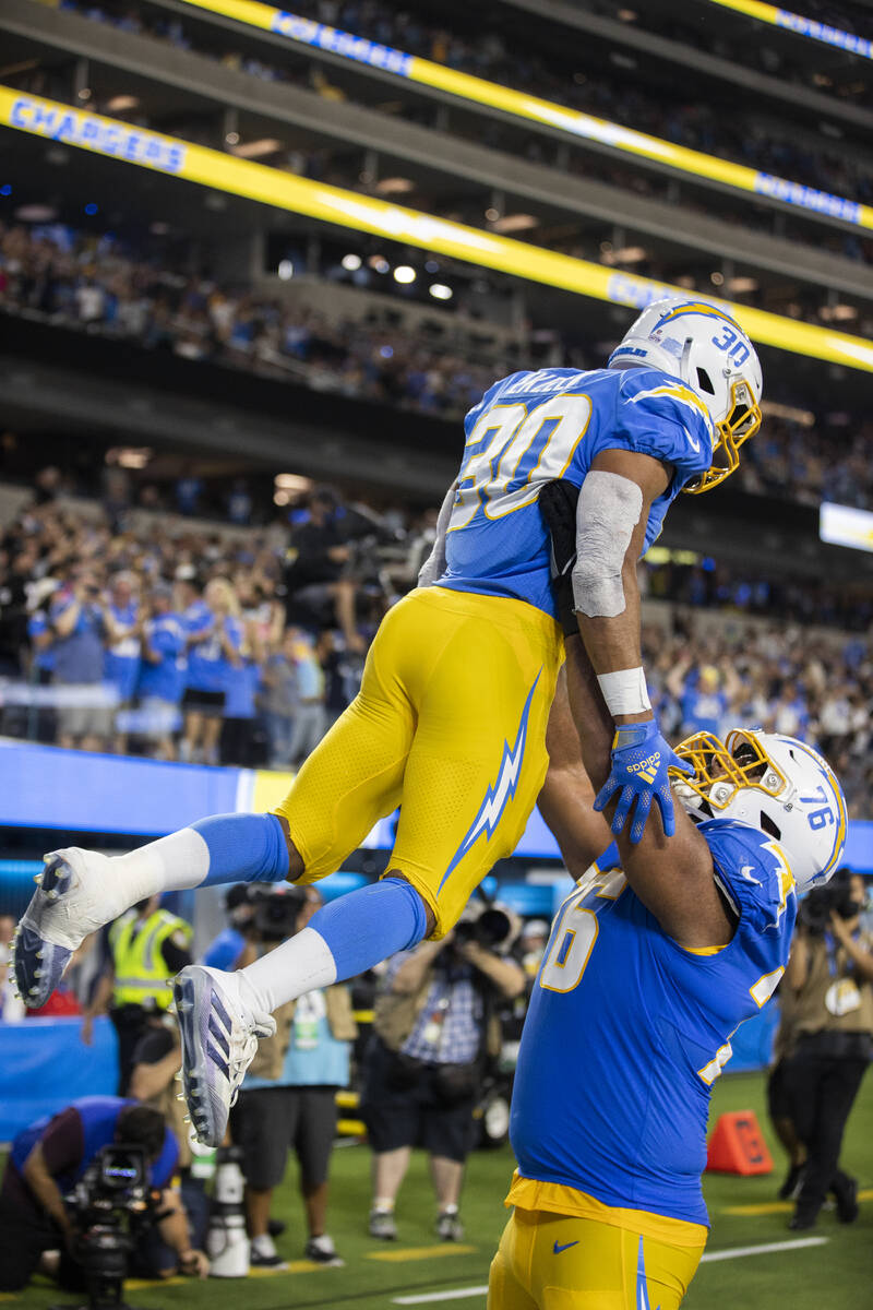 Los Angeles Chargers running back Austin Ekeler (30) celebrates a touchdown with Los Angeles Ch ...