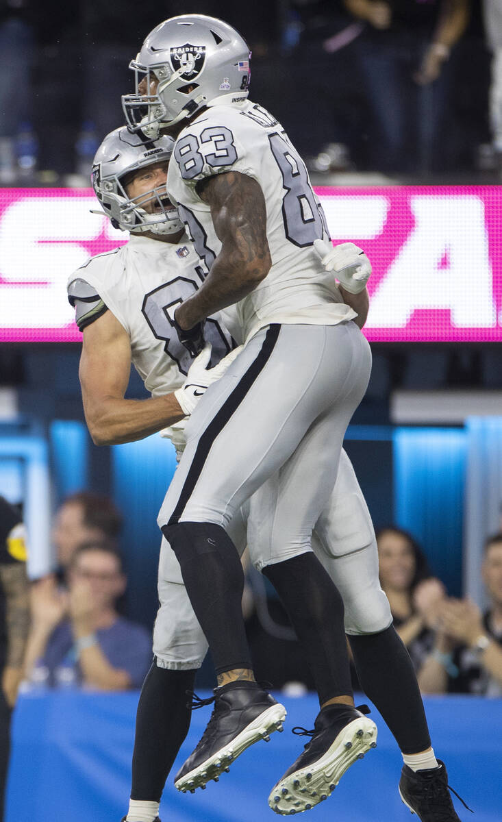 Raiders tight end Darren Waller (83) celebrates a touchdown catch with Raiders tight end Foster ...