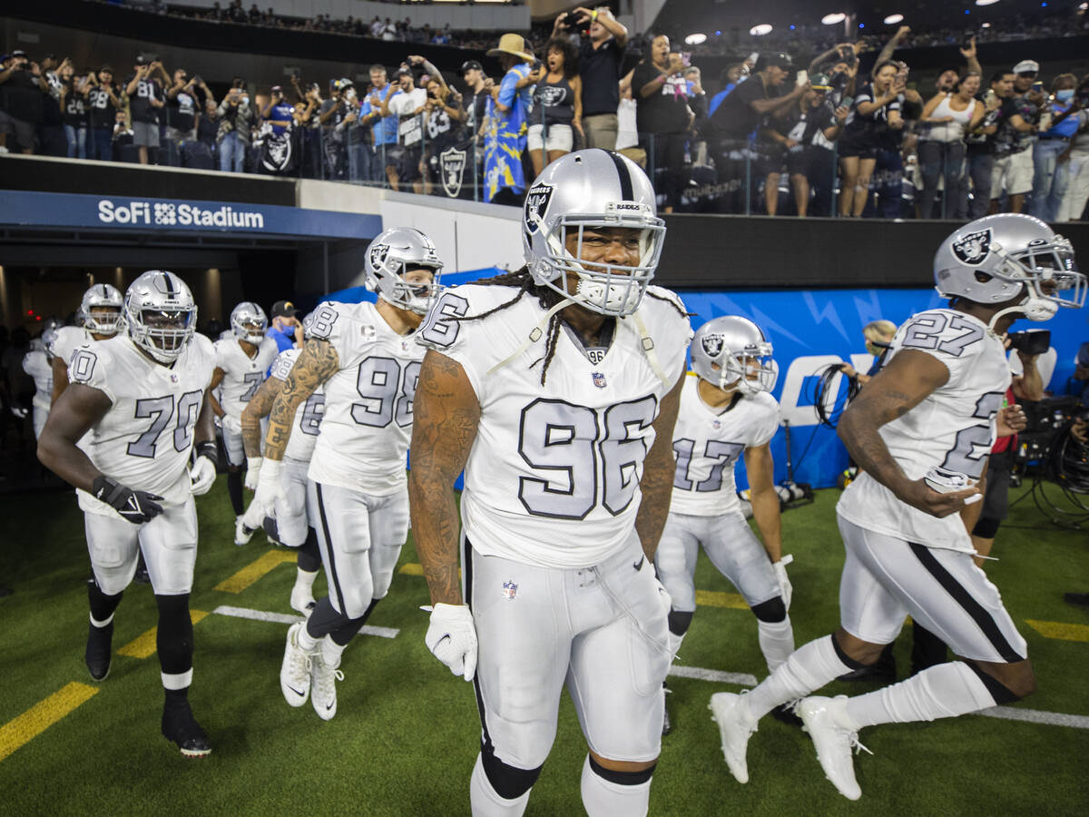 The Raiders take the field before the start of an NFL football game against the Los Angeles Cha ...