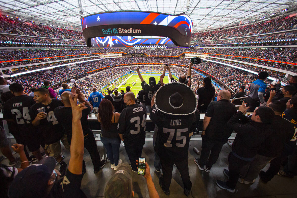 Raiders cheer at the end of the national anthem before the first half of an NFL game against th ...