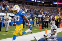 Los Angeles Chargers running back Austin Ekeler (30) scores a touchdown past Raiders outside li ...