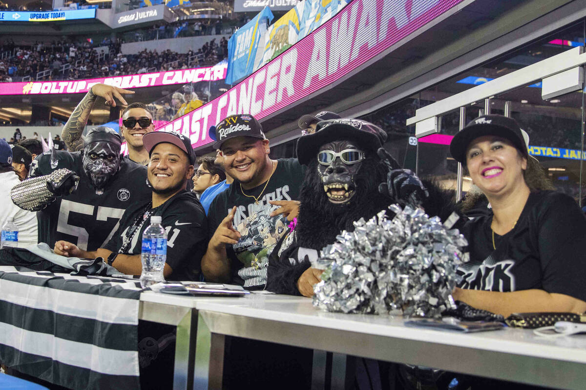 Raiders fans pose for a photo before an NFL football game between the Raiders and the Los Angel ...