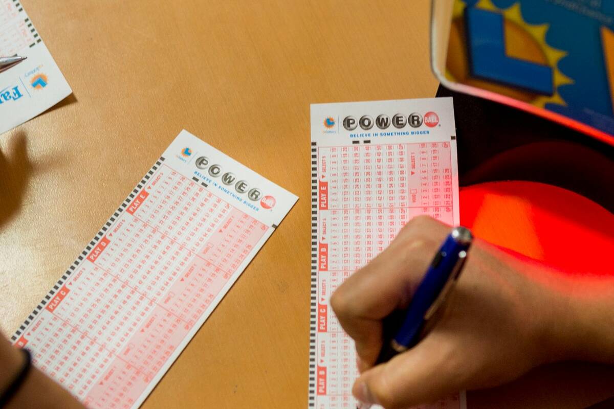 People fill out their numbers on a Powerball ticket at the Primm Valley Lotto Store in August 2 ...