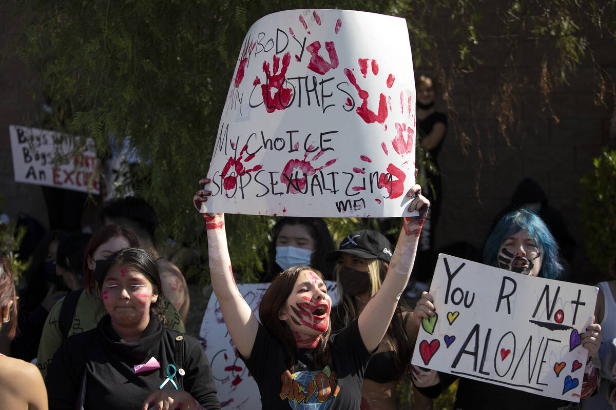 Freshman Lily Reynolds, center, protests outside Coronado High School alongside about 100 fello ...