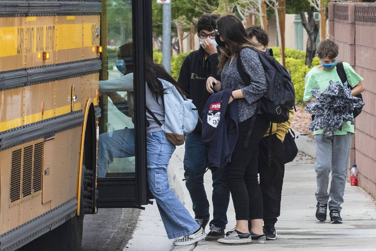 Students board the school bus at Odette Lane and Charleston Boulevard, on Tuesday, Oct. 5, 2021 ...