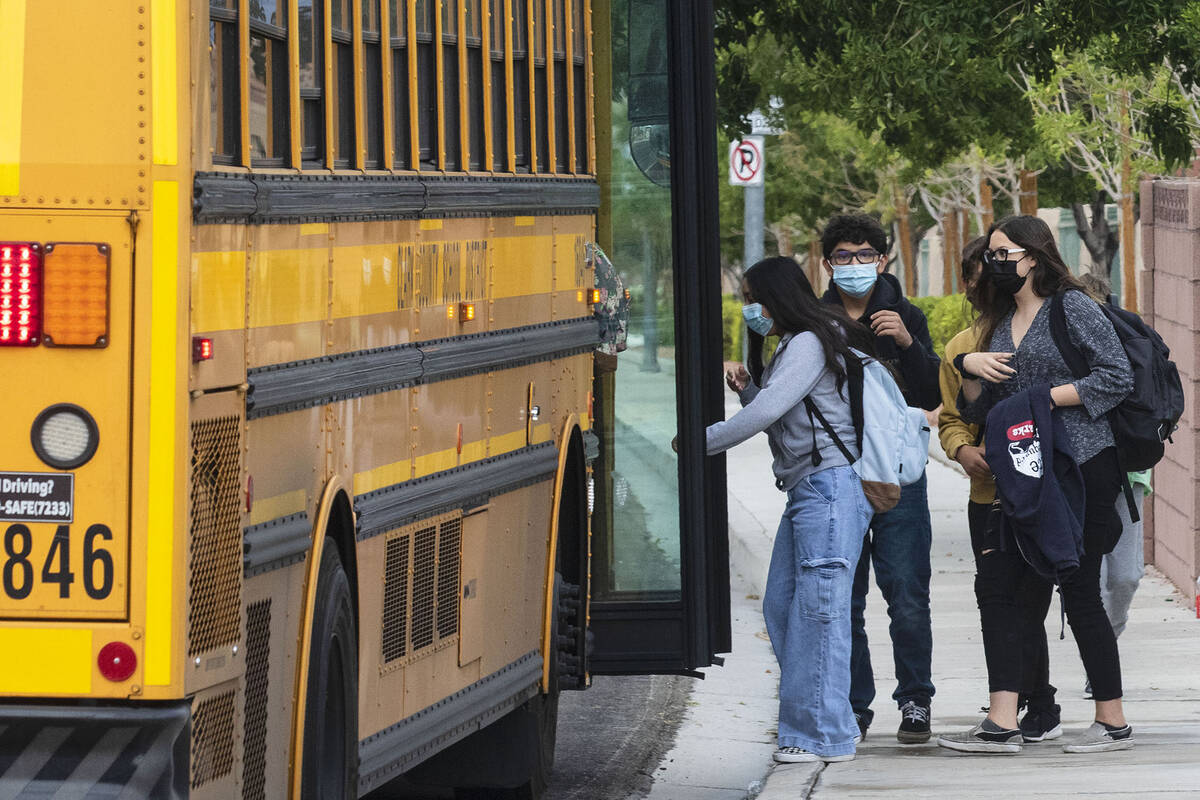 Students board the school bus at Odette Lane and Charleston Boulevard, on Tuesday, Oct. 5, 2021 ...