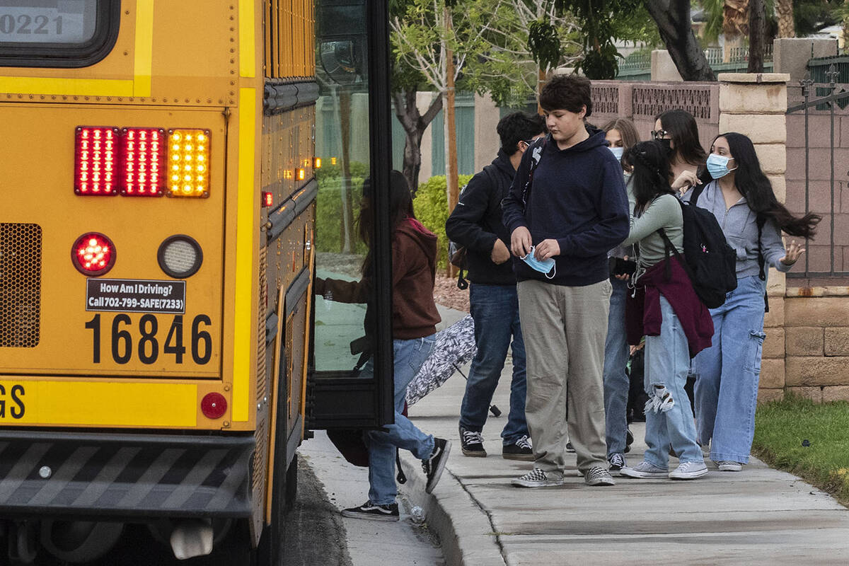 Students board the school bus at Odette Lane and Charleston Boulevard, on Tuesday, Oct. 5, 2021 ...