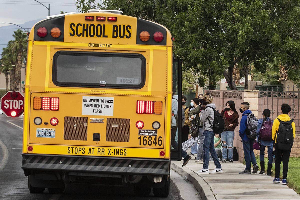 Students board the school bus at Odette Lane and Charleston Boulevard, on Tuesday, Oct. 5, 2021 ...