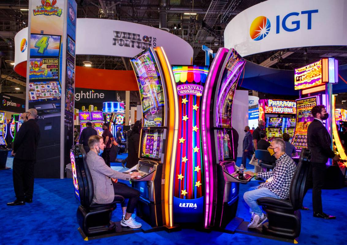 Attendees play the Carnival of Wonders machines in the IGT display space during day 2 of the Gl ...