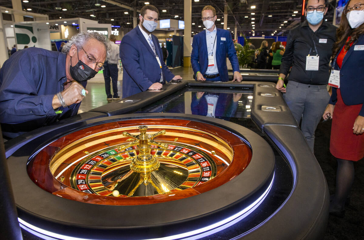 Attendee Ronald Gregrich hopes for a winner on a Roulette wheel at the tangiamo display area du ...