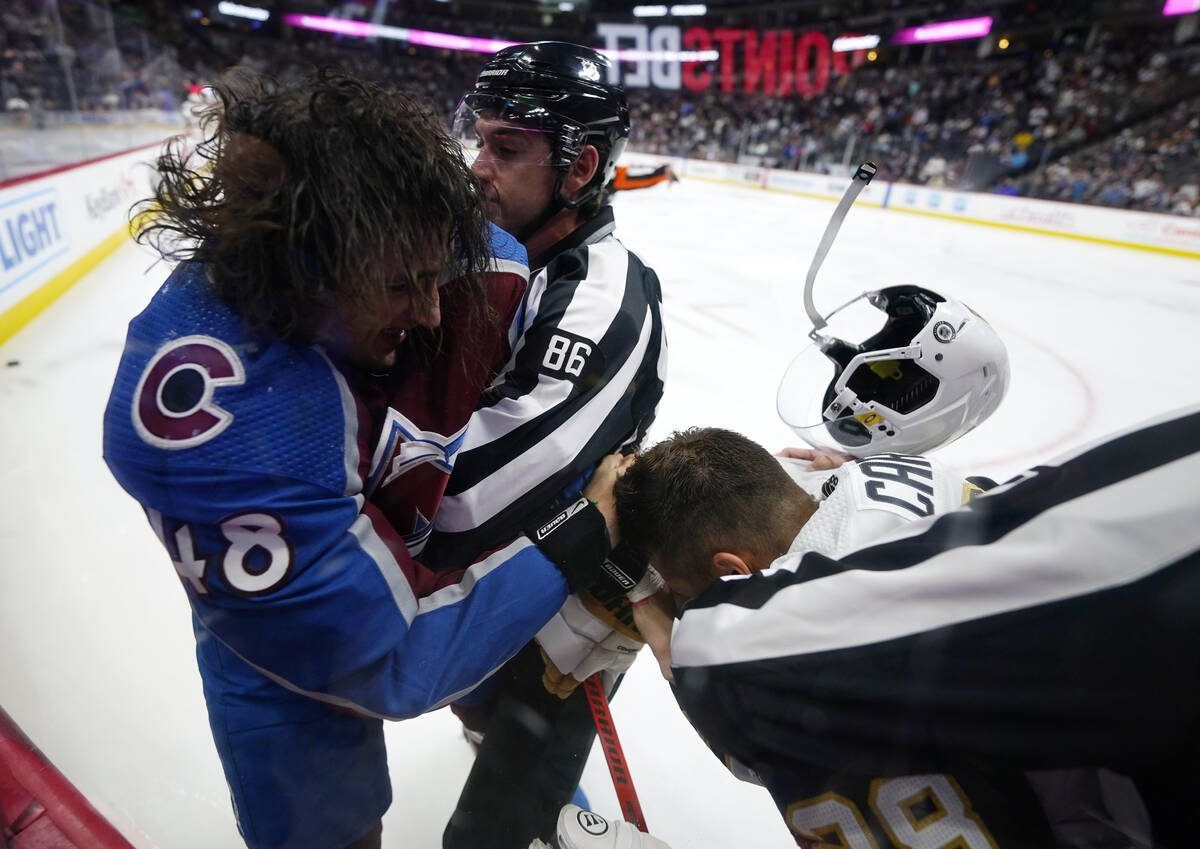 Colorado Avalanche defenseman Dennis Gilbert (48) punches Vegas Golden Knights left wing Willia ...
