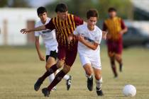 Eldorado's Jorge Sandoval (19) competes for the ball against Centennial's Ethan Leveque (6) dur ...