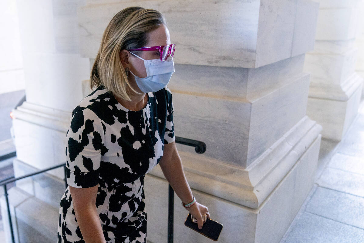 Sen. Kyrsten Sinema, D-Ariz., arrives at the U.S. Capitol for votes, Wednesday, Sept. 29, 2021, ...