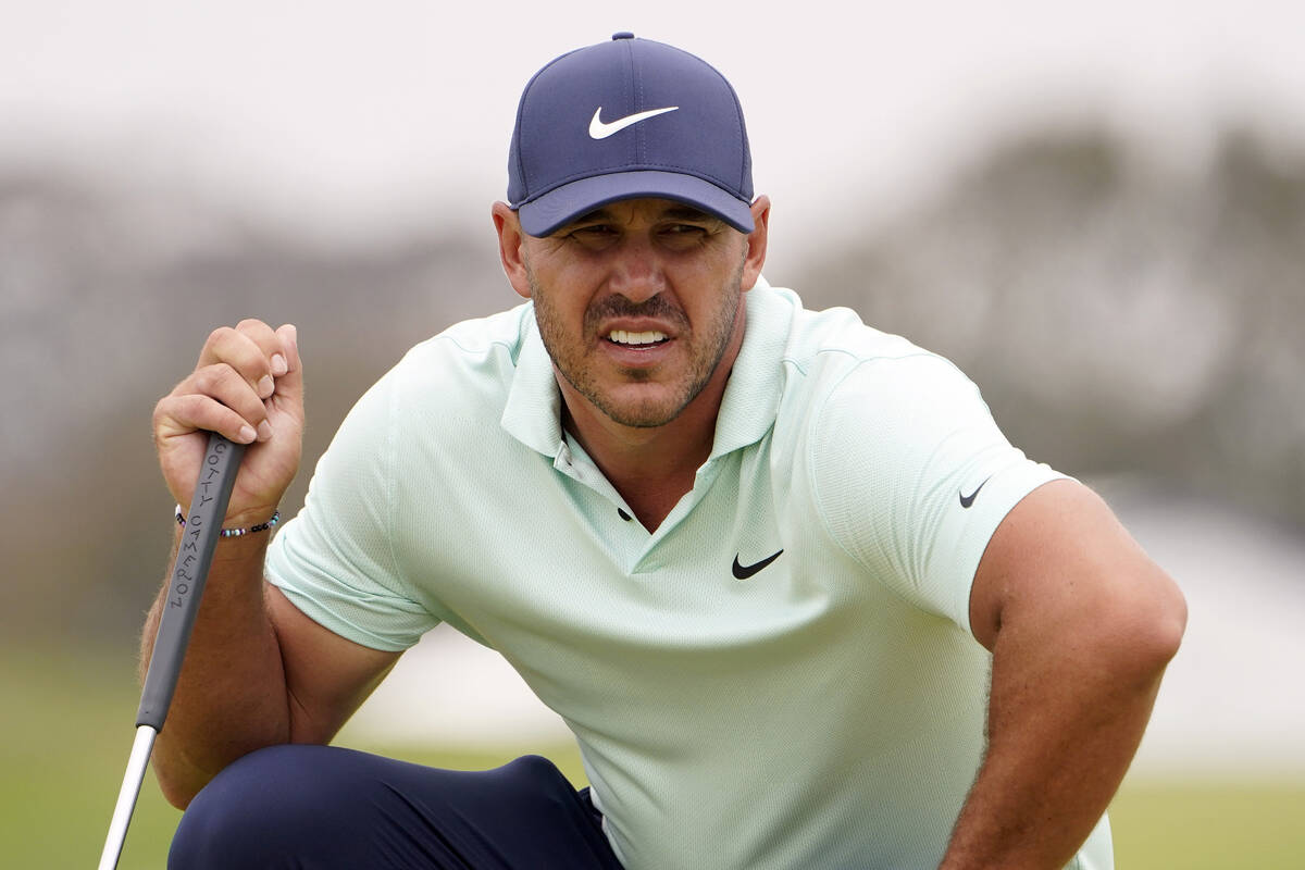 In this June 19, 2021, file photo, Brooks Koepka studies the second green during the third roun ...