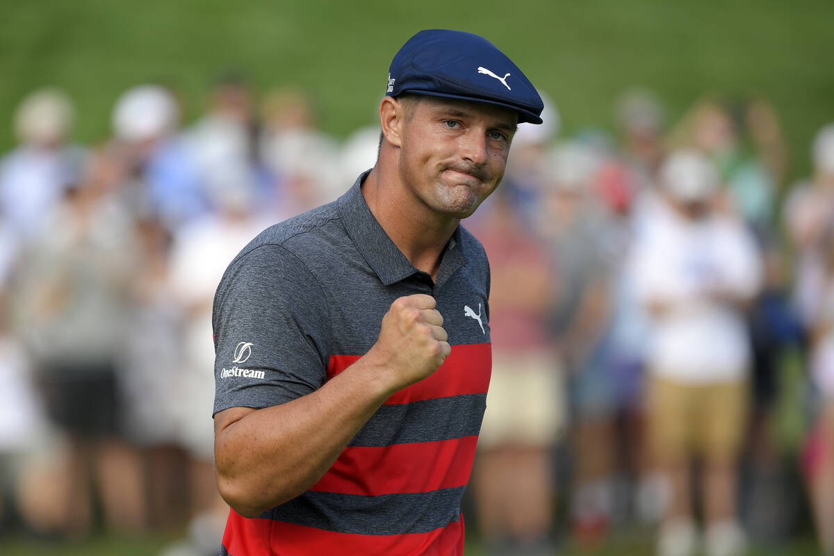 In this Aug. 29, 2021, file photo, Bryson DeChambeau reacts after sinking his putt on the 16th ...