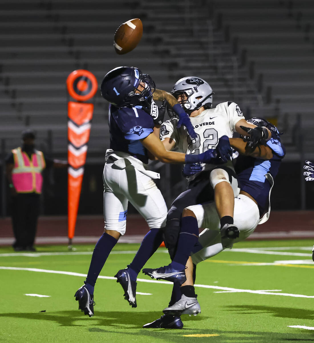 Canyon Springs' Ricardo Pulcher (1) and Canyon Springs' running back Kenneth Jacobs (7) break u ...