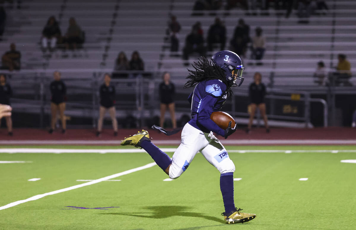 Canyon Springs' Dionn Whittaker (3) runs with the ball after a reception to score a touchdown a ...