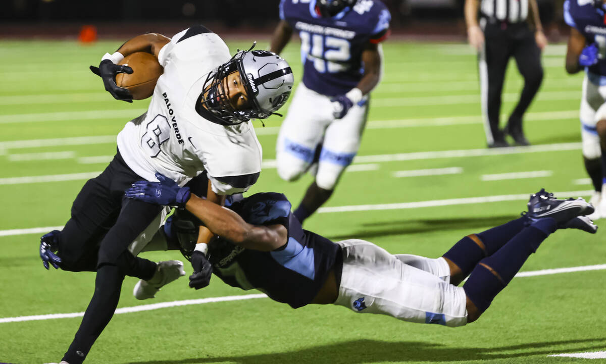 Palo Verde's Jimmie Moody (8) gets tackled by Canyon Springs' Kenneth Jacobs (7) during the fir ...