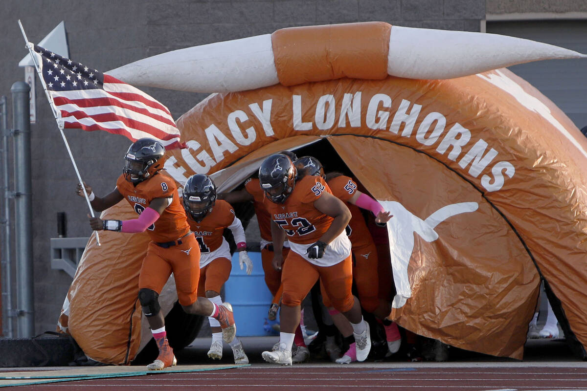 Legacy High School's players run out to the field before a football game against Bishop Gorman ...