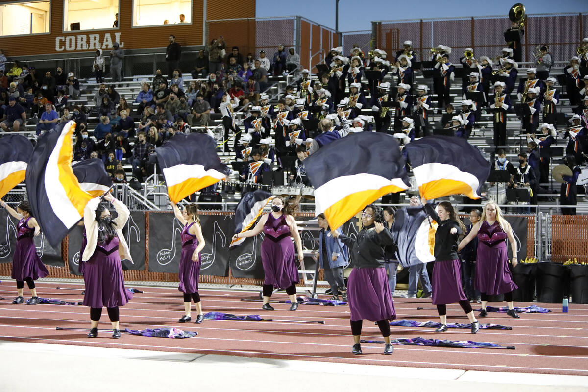 Legacy High School's color guards and marching band perform during the first half of a football ...