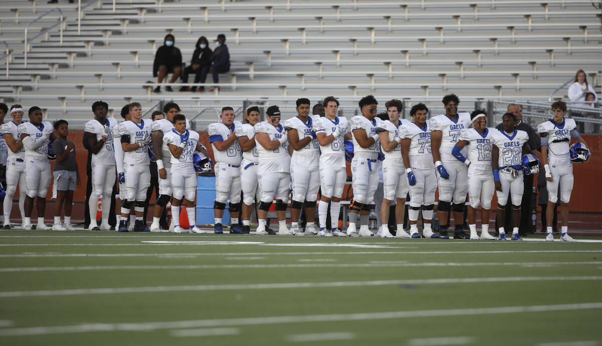 Bishop Gorman High School's players line up for the national anthem before a football game agai ...
