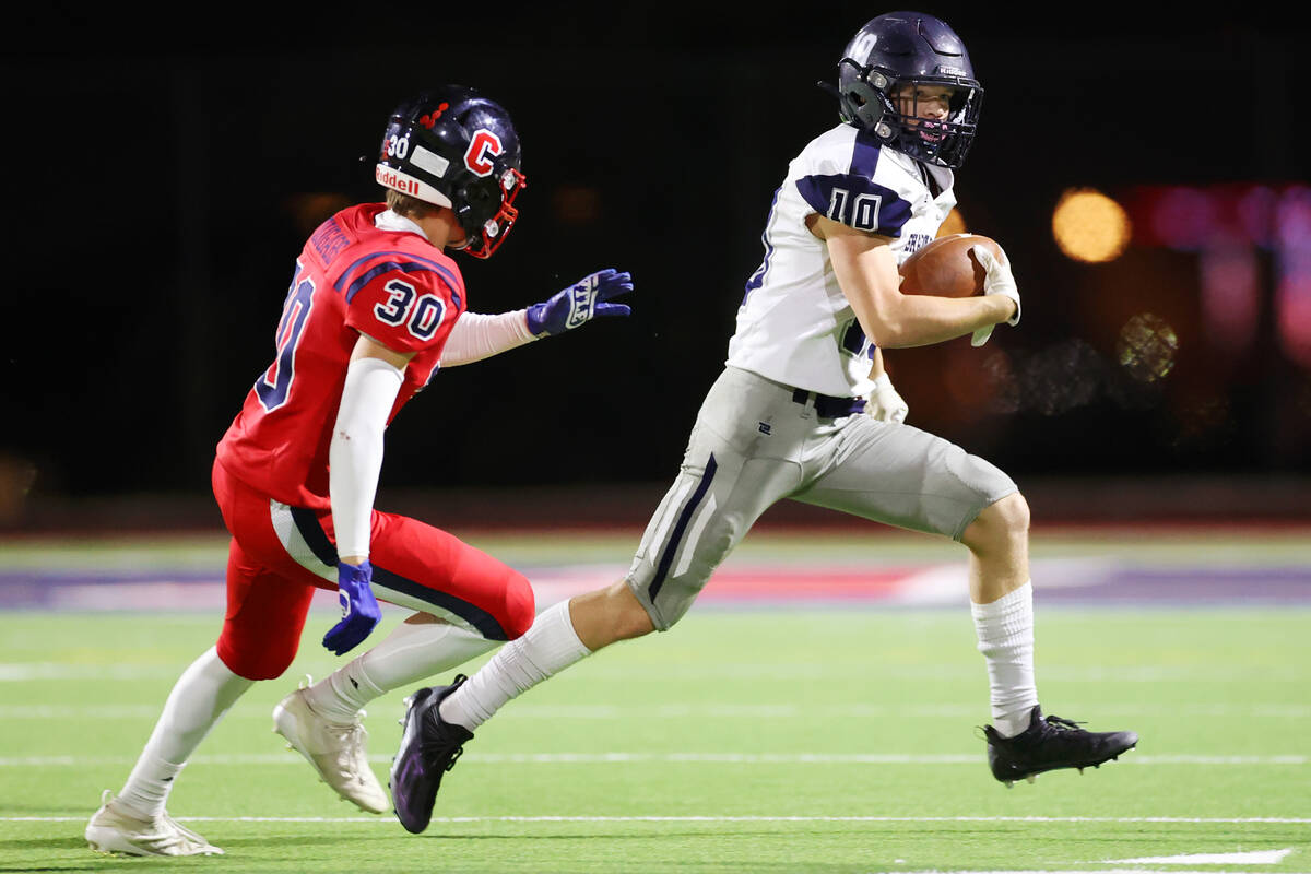 Shadow Ridge's Maddyx Valenzuela (10) runs the ball under pressure from Coronado's Jacob Heiny ...