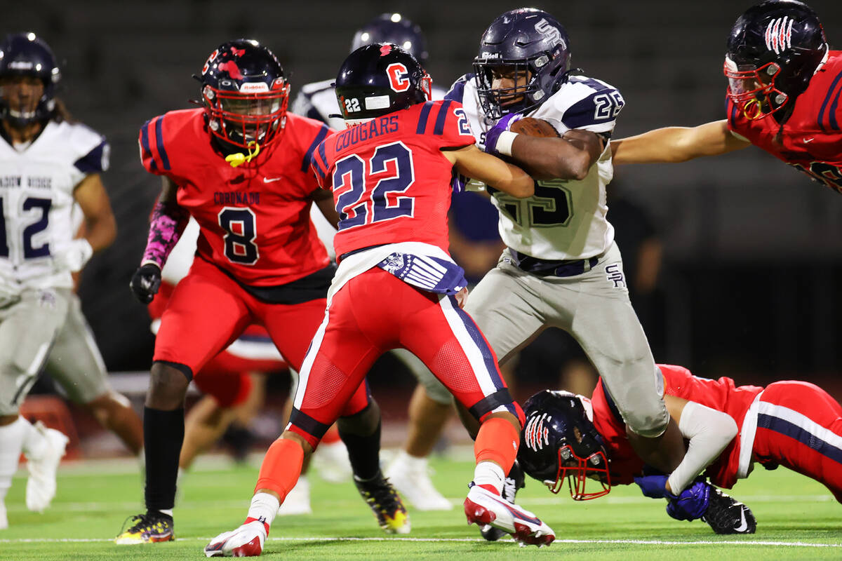 Shadow Ridge's Jaquieze Holland (25) runs the ball before getting tackled by Coronado's Jeremia ...