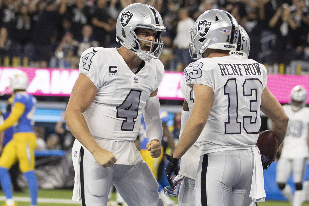 Raiders quarterback Derek Carr (4) celebrates a touchdown with Raiders wide receiver Hunter Ren ...