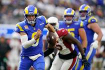 Los Angeles Rams quarterback Matthew Stafford rolls out during the second half in an NFL footba ...