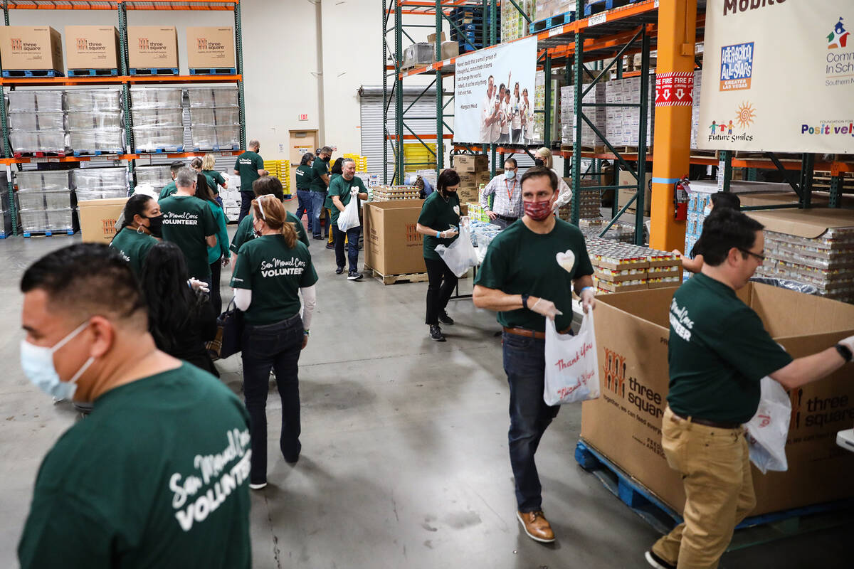Members of the San Manuel Band of Mission Indians pack bags of food for the BackPack for Kids p ...