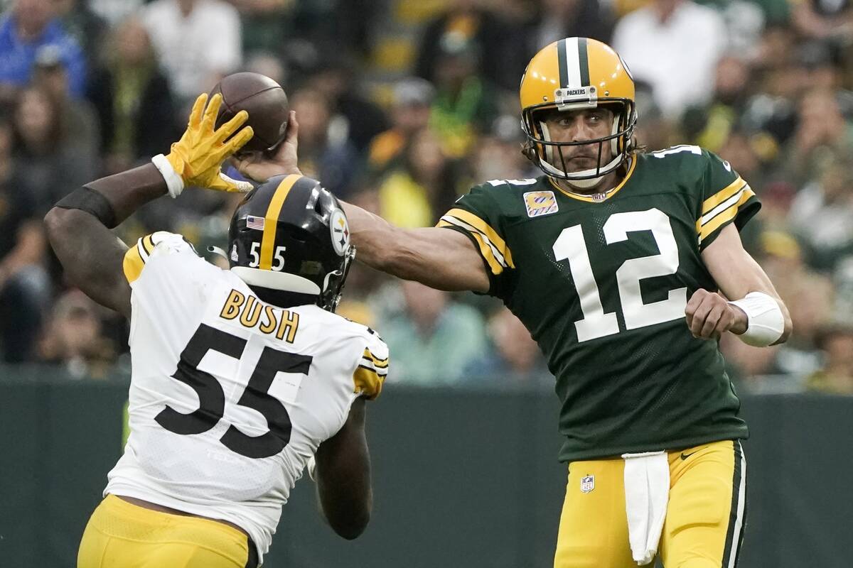 Green Bay Packers' Aaron Rodgers throws past Pittsburgh Steelers' Devin Bush during the second ...