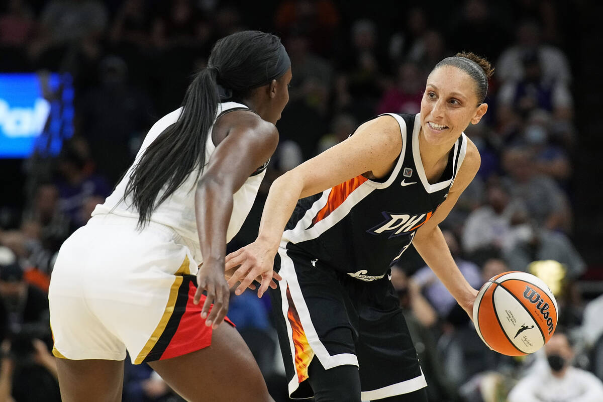 Phoenix Mercury guard Diana Taurasi, right, shields the ball from Las Vegas Aces guard Kelsey P ...