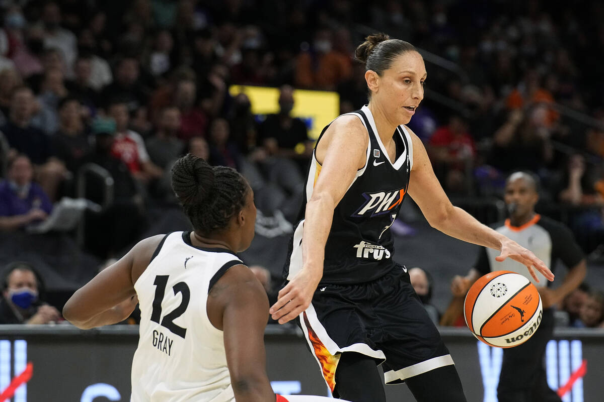 Phoenix Mercury guard Diana Taurasi draws the blocking foul on Las Vegas Aces guard Chelsea Gra ...