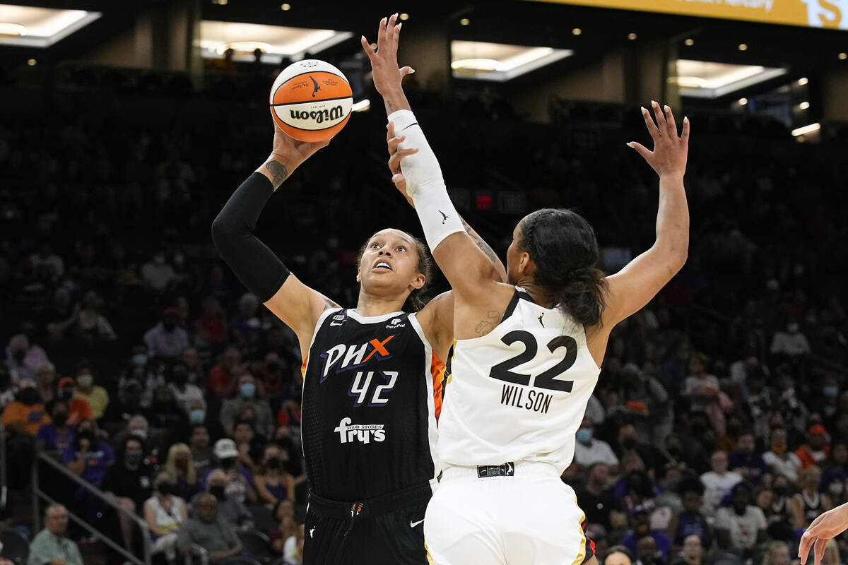 Phoenix Mercury center Brittney Griner drives on Las Vegas Aces forward A'ja Wilson (22) during ...