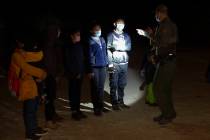 FILE - In this March 28, 2021 file photo Migrants from Guatemala and Honduras are questioned by ...