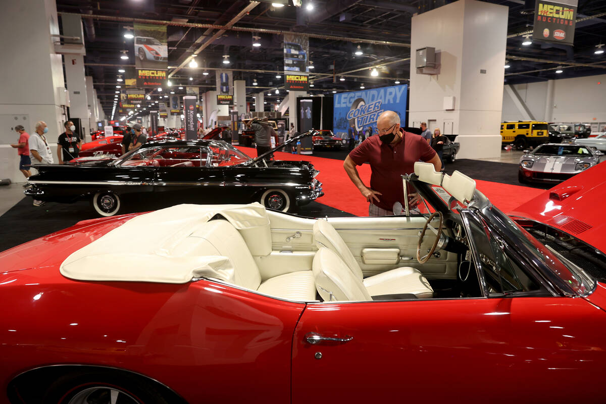 Marc Brisson of Alpharetta, Ga. checks out a 1968 Pontiac GTO convertible during Mecum Las Vega ...