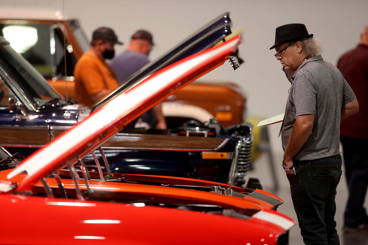 Larry Gaasterland of Sunnyvale, Calif. checks out cars during Mecum Las Vegas auction at the La ...