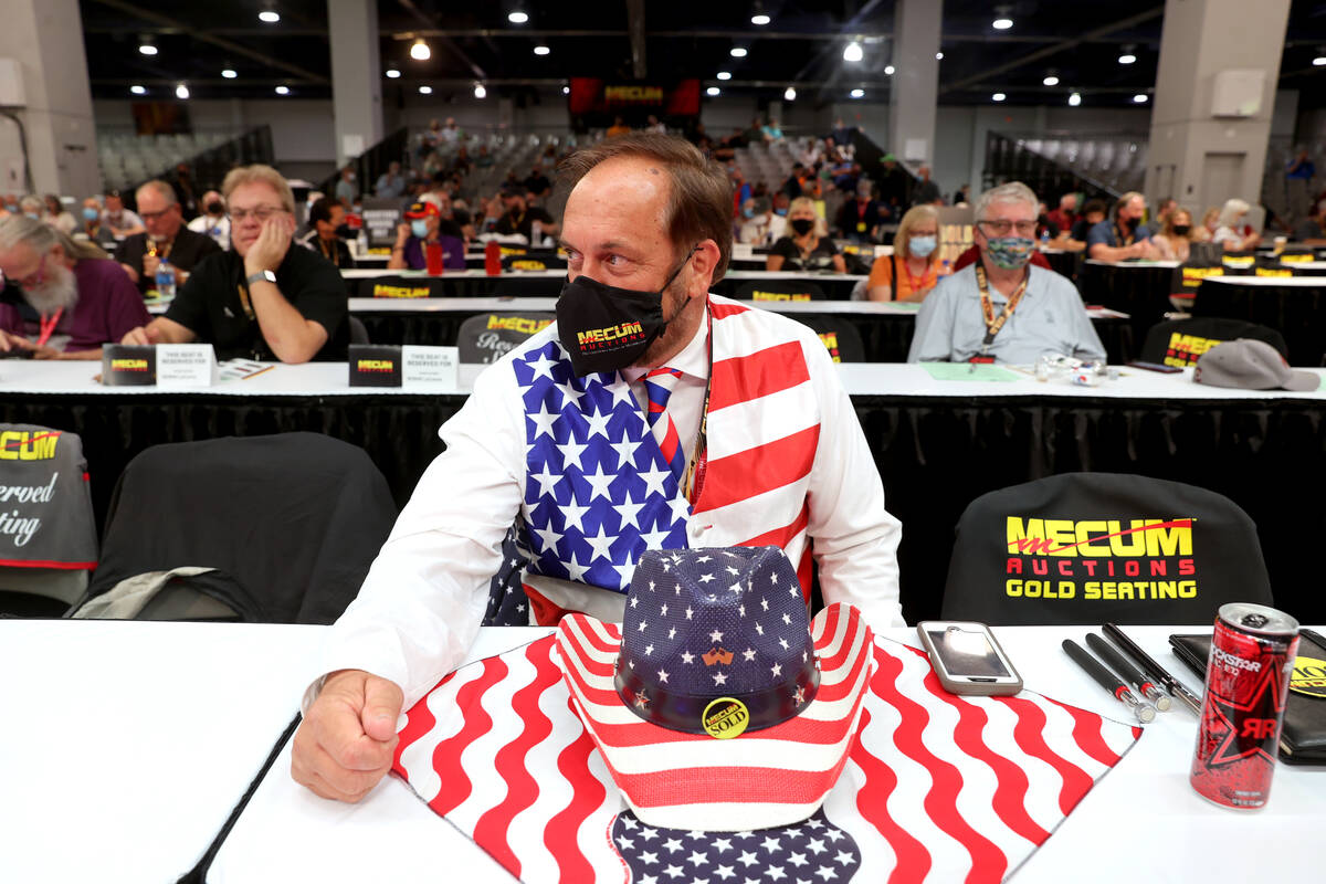 Greg Prante of St. Louis, Mo. prepares to bid on cars during Mecum Las Vegas auction at the Las ...