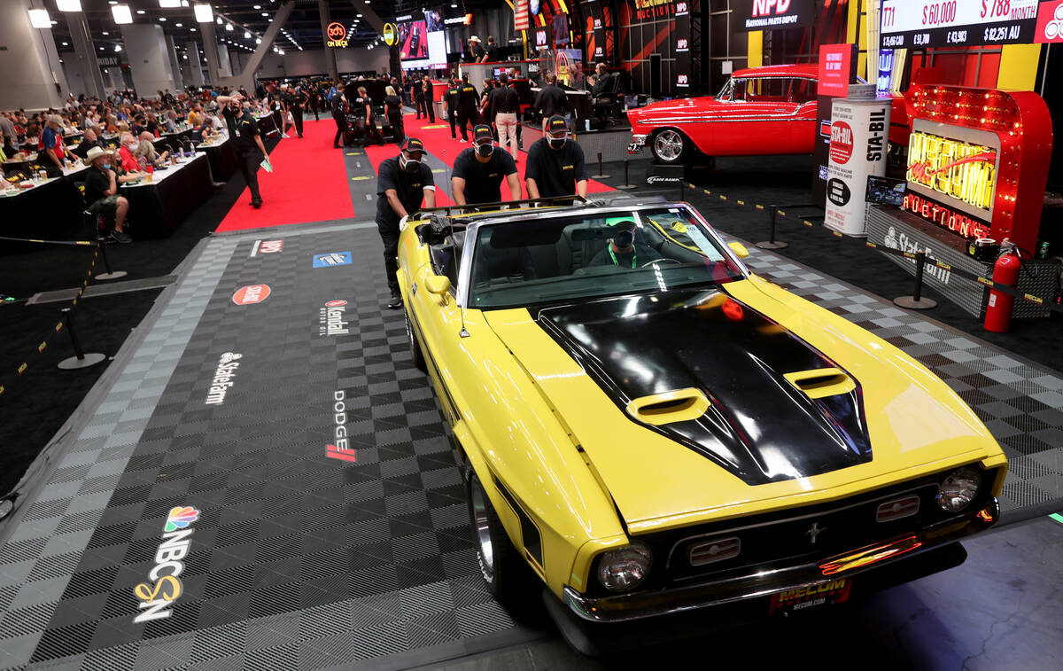 Bidders check out a 1972 Ford Mustang convertible during Mecum Las Vegas auction at the Las Veg ...