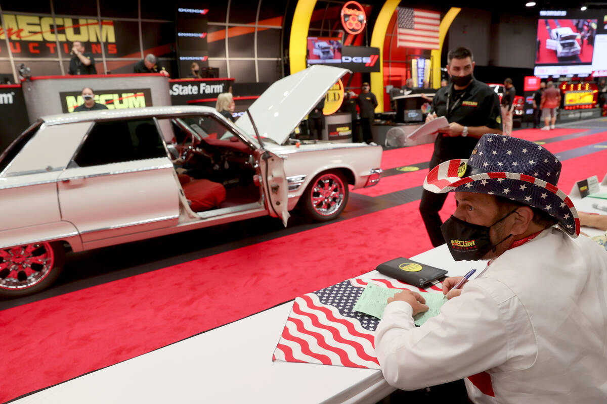 Greg Prante of St. Louis, Mo. prepares to bid on cars during Mecum Las Vegas auction at the Las ...